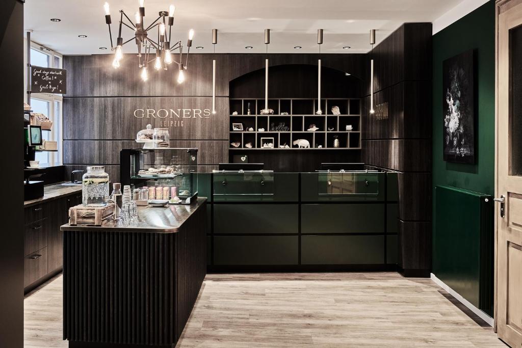 a kitchen with green cabinets and a counter at GRONERS Leipzig City Center in Leipzig