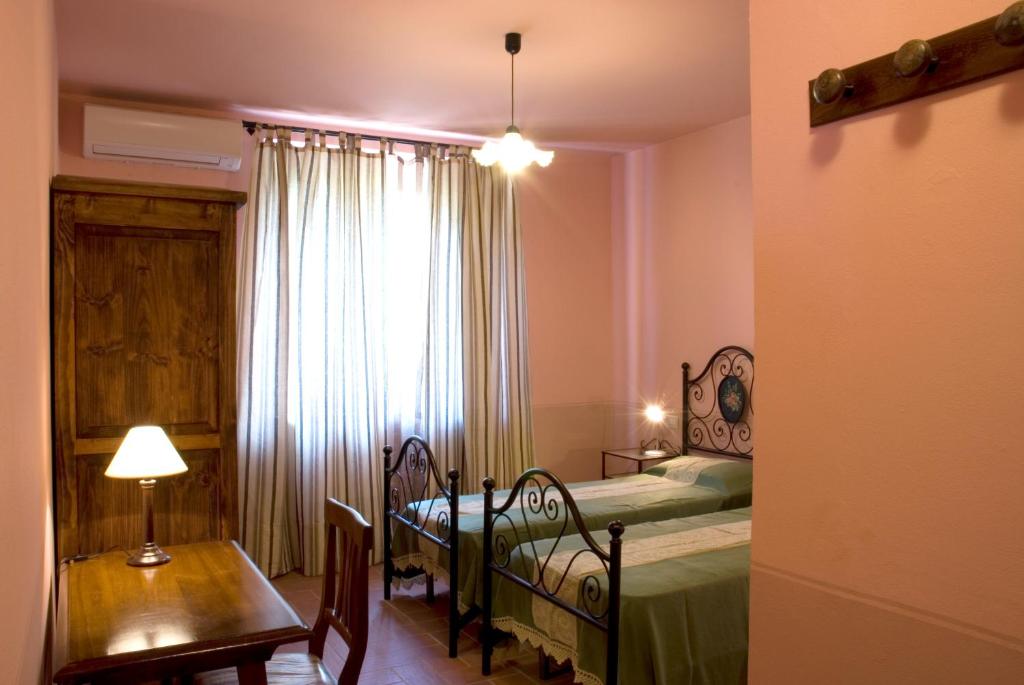 Postel nebo postele na pokoji v ubytování Villa Bellaria Lucignano