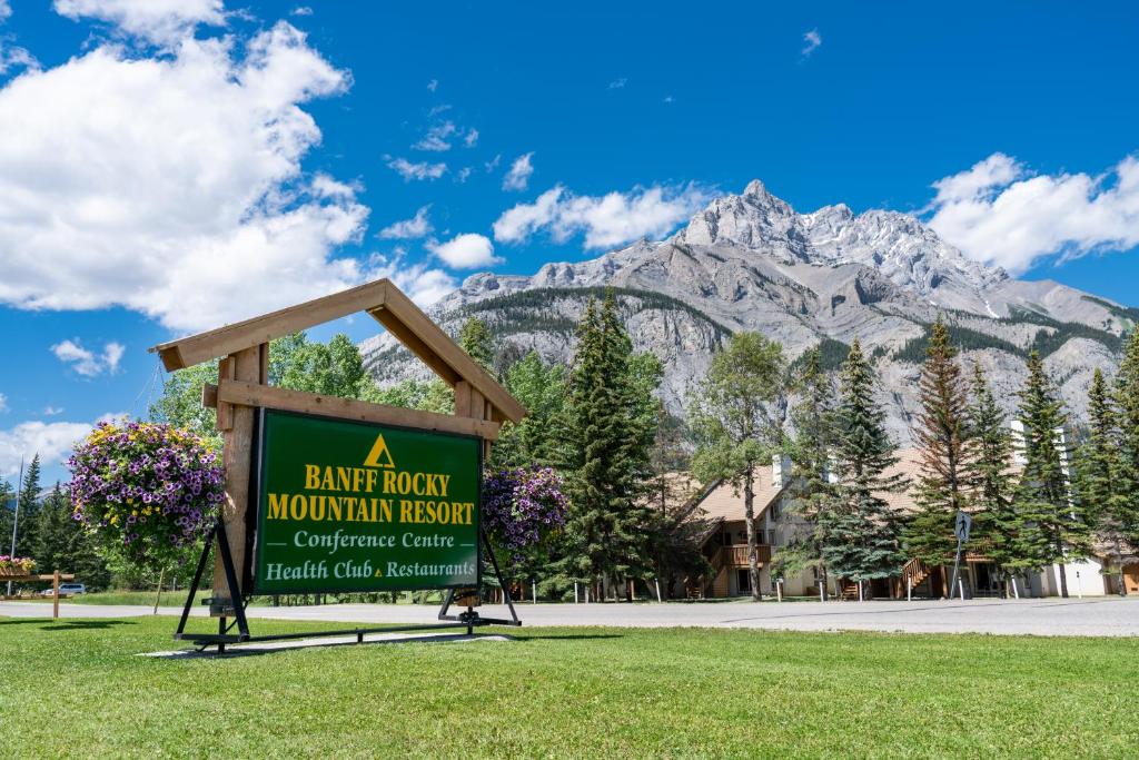a sign with a mountain in the background at Banff Rocky Mountain Resort in Banff
