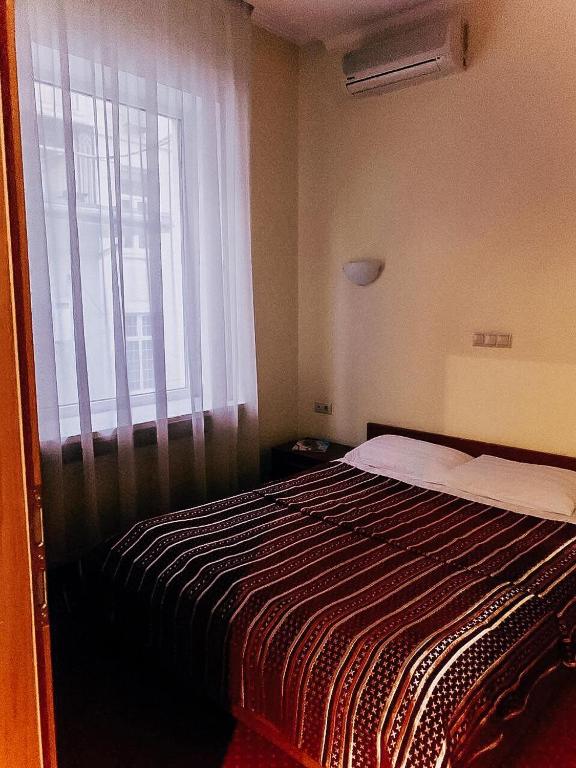 Postel nebo postele na pokoji v ubytování Residence Odesskij Dvorik