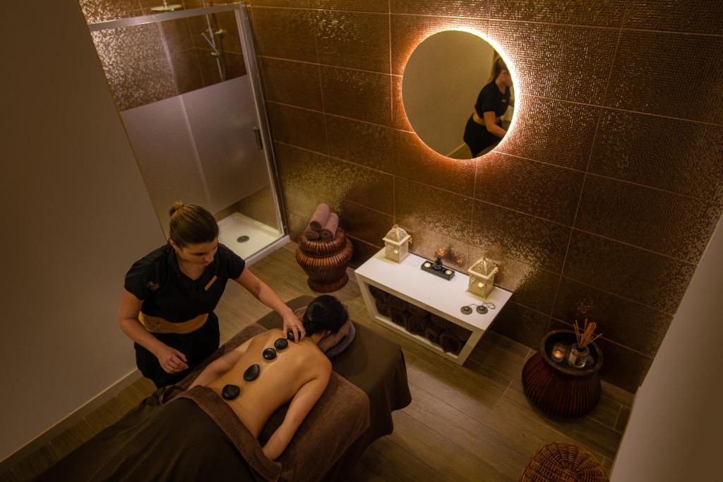 a man getting a bath in a bathroom at Monte Santo Resort in Carvoeiro