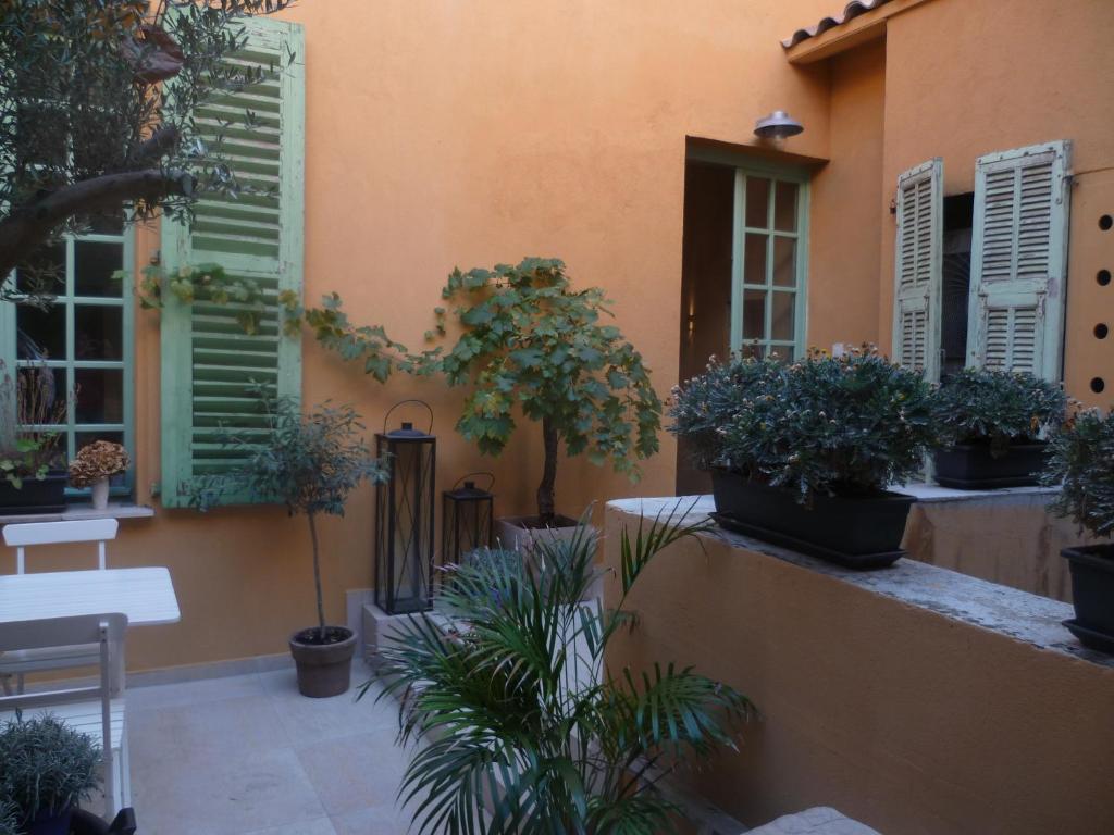 a patio with potted plants on a building at Hotel Rossetti in Nice