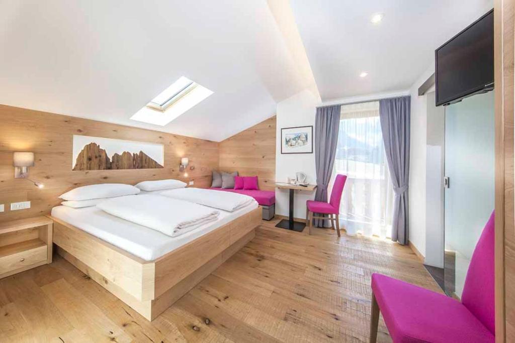 Postel nebo postele na pokoji v ubytování Hotel Garni Morene