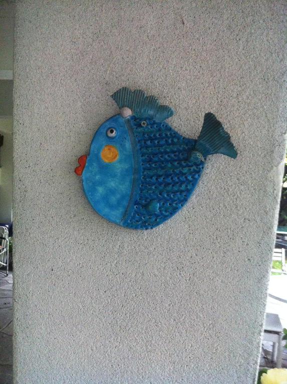 a blue fish hanging on a wall at B&B Le Ortensie -Lago di Como in Lierna