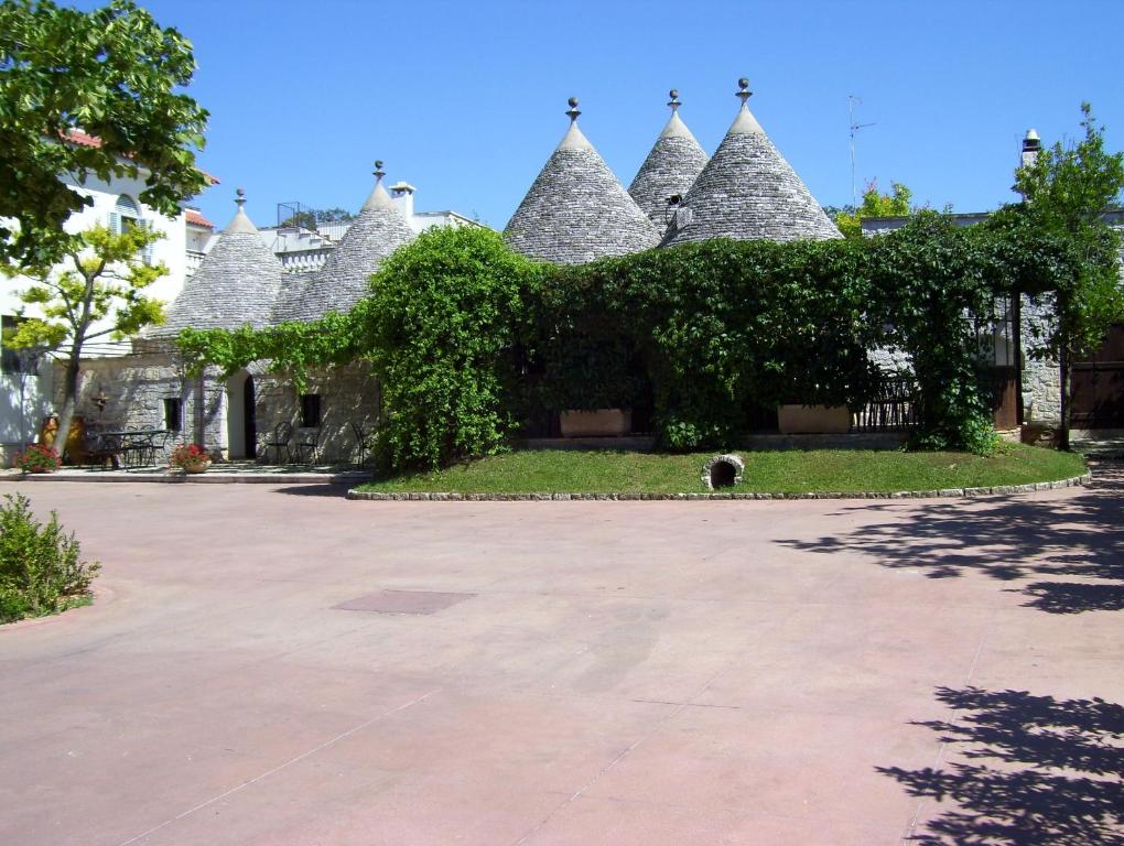 a building with a dog standing in front of it at Agriturismo Locanda Ventura in Fasano