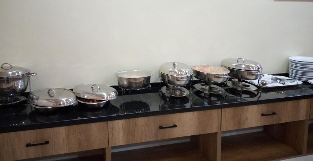 a group of pots and pans on a stove in a kitchen at Lit Suites in Abuja