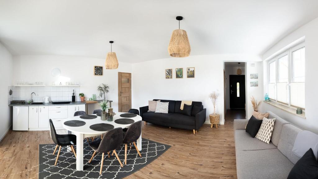 a living room with a table and a couch at Apartament Latarnika in Jarosławiec