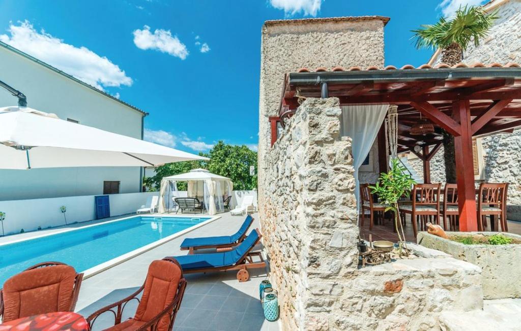 a villa with a swimming pool and a patio at 4 bedrooms villa with private pool enclosed garden and wifi at Jezera in Jezera