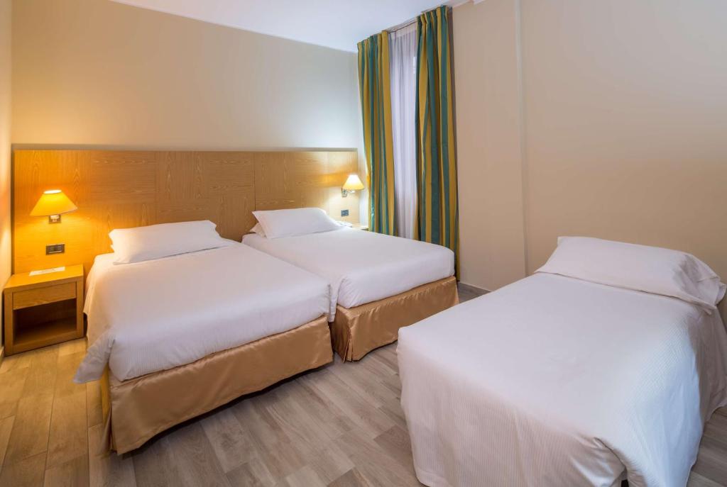 Postel nebo postele na pokoji v ubytování Best Western Cavalieri Della Corona