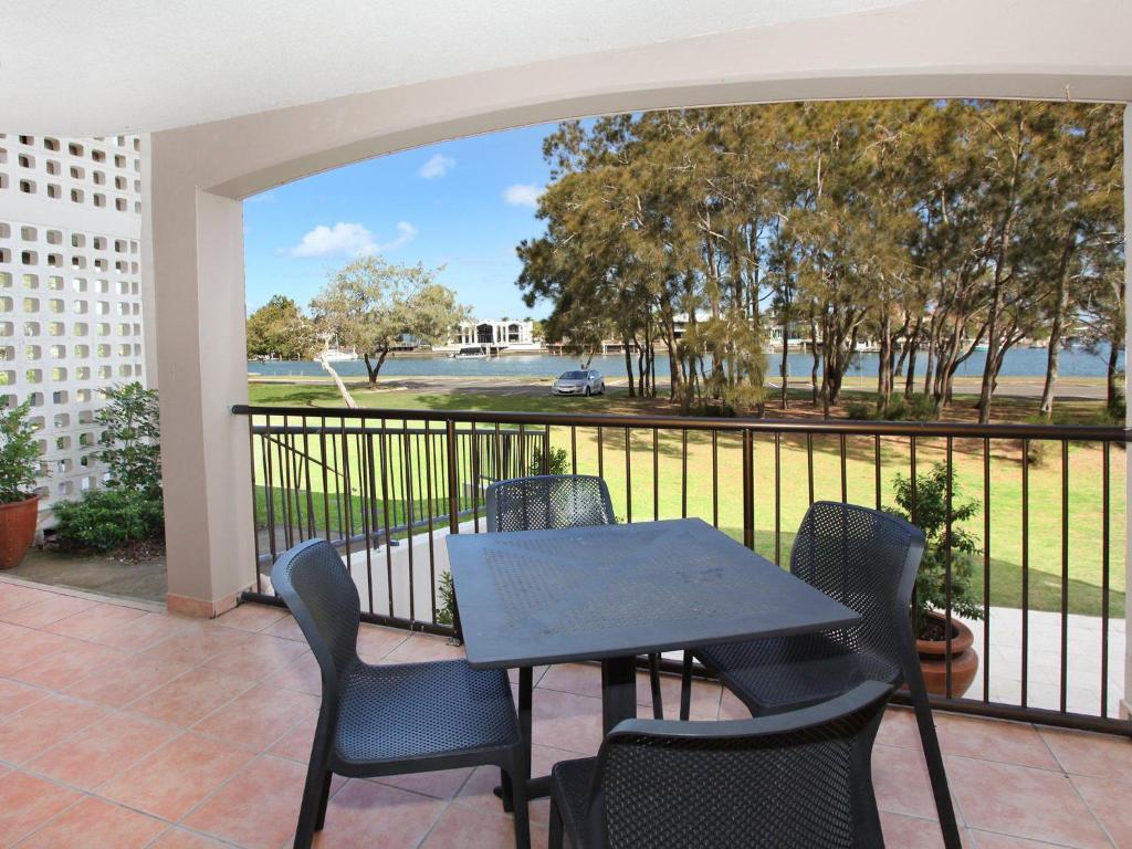 a patio with a table and chairs on a balcony at 2 bedroom Apt on Parkyn Parade with pool and Airvconditioning in Mooloolaba