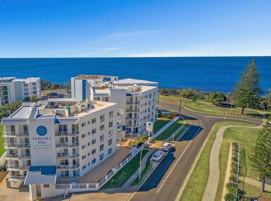 an aerial view of a building next to the ocean at Bargara Blue Resort in Bargara