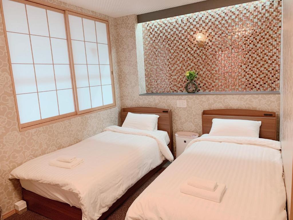 Postel nebo postele na pokoji v ubytování Allcomein Hotel Akihabara
