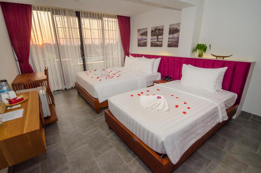Postel nebo postele na pokoji v ubytování Neth Socheata Hotel
