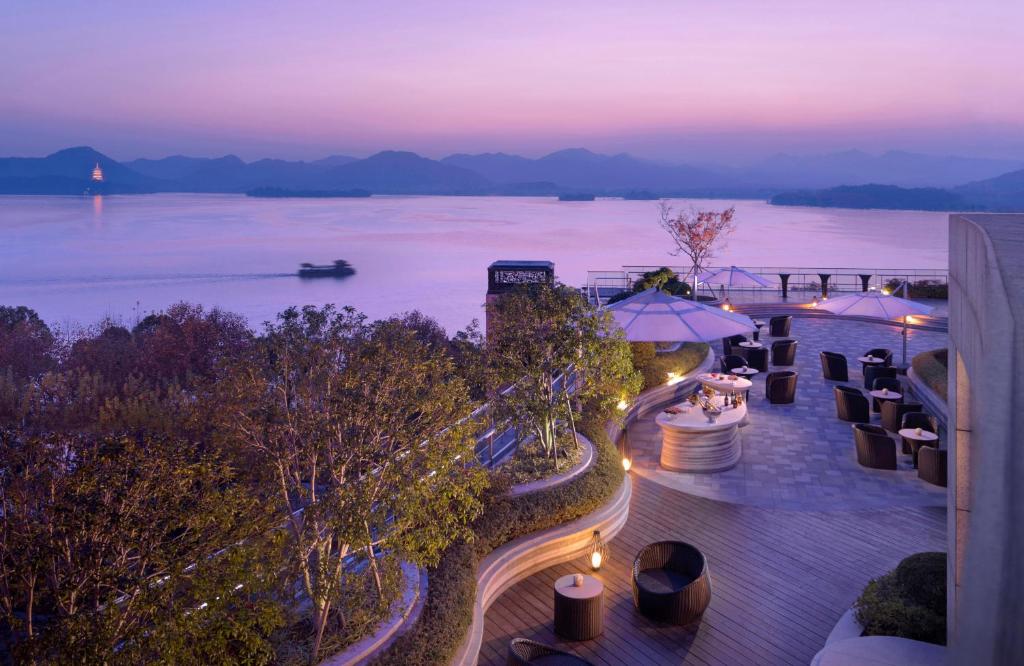 a view of the water from a resort at night at Grand Hyatt Hangzhou in Hangzhou