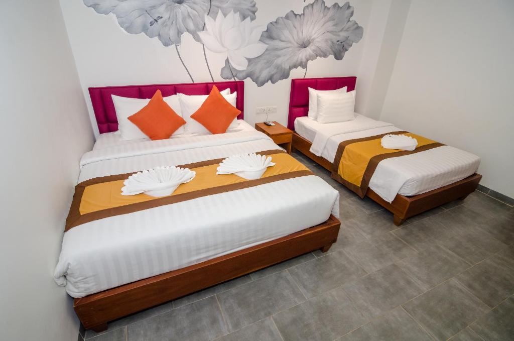 Postel nebo postele na pokoji v ubytování Neth Socheata Hotel