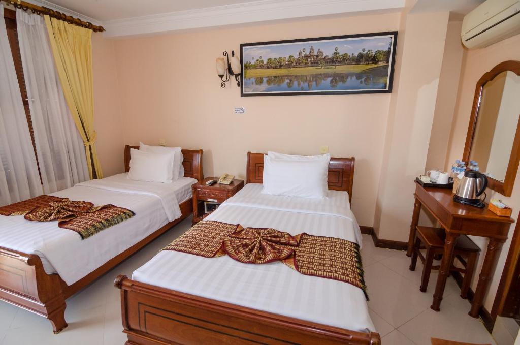 Postel nebo postele na pokoji v ubytování Neth Socheata Hotel