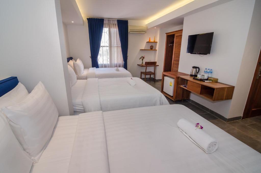 Postel nebo postele na pokoji v ubytování Neth Socheata Hotel