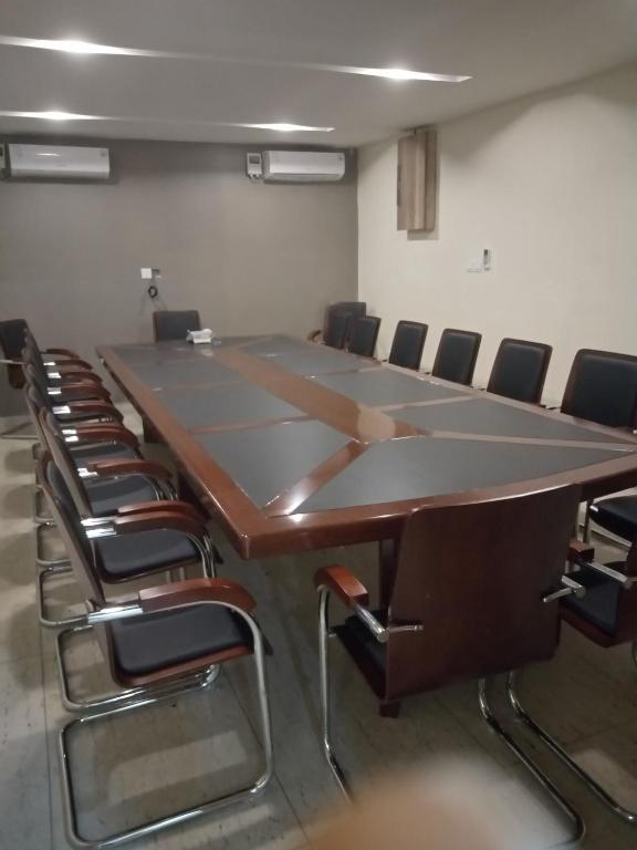 a large conference room with a large table and chairs at Lit Suites in Abuja