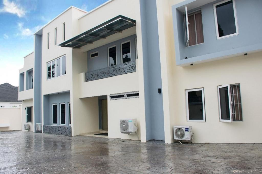 a large white building with a lot of windows at Lit Suites in Abuja