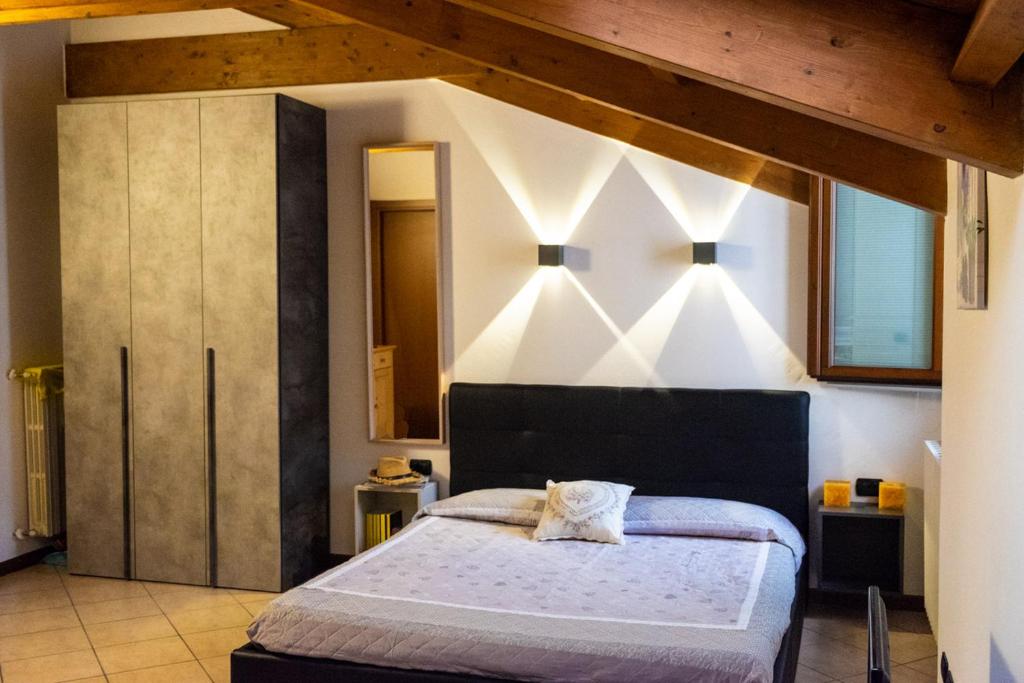 a bedroom with a large bed in a room at Monolocale vicino Milano CIR 00014 in Lodi