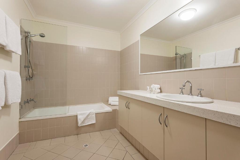 a bathroom with a sink, toilet and bathtub at Best Western Northbridge Apartments in Perth