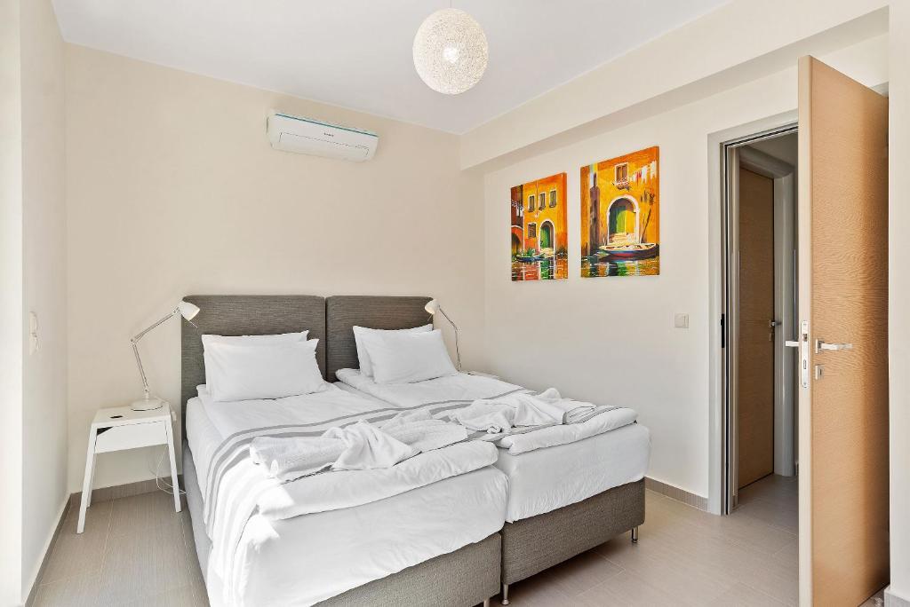 A bed or beds in a room at Almyrida Panorama view house BY APOKORONAS-VILLAS