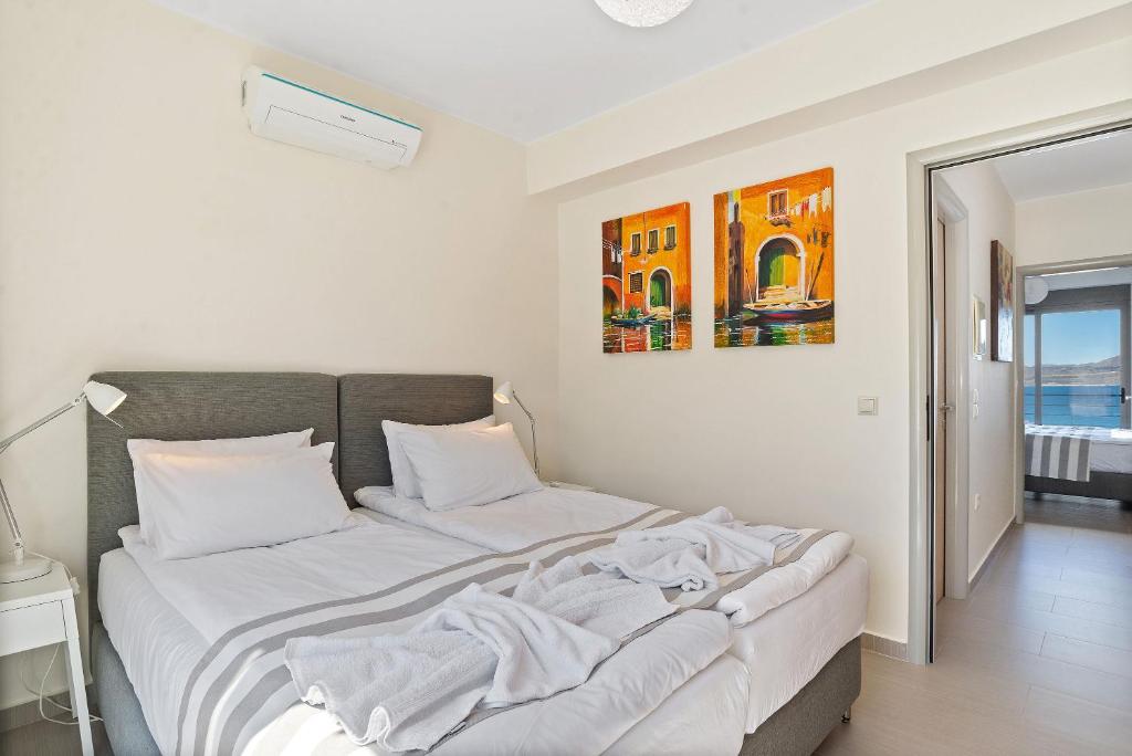A bed or beds in a room at Almyrida Panorama view house BY APOKORONAS-VILLAS