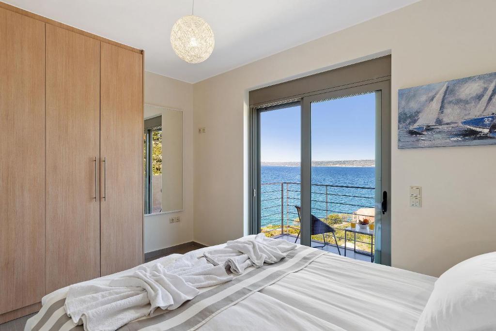 A bed or beds in a room at Almyrida Panorama view house BY APOKORONAS-VILLAS