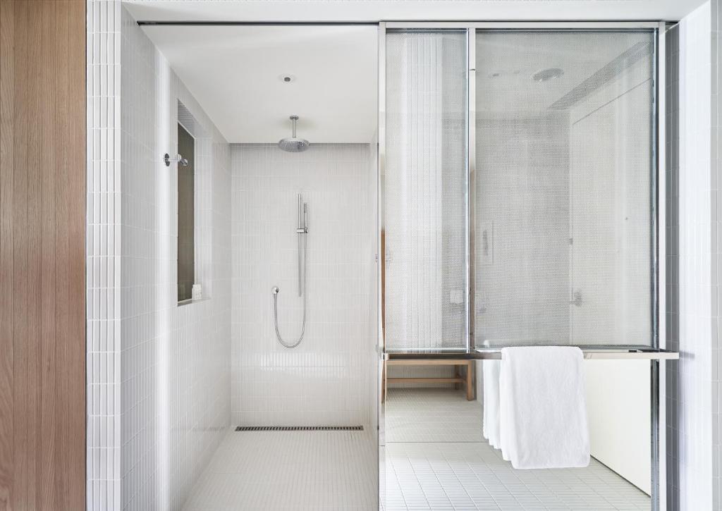 a bathroom with a shower with a glass door at Kimpton Da An Taipei- an IHG Hotel in Taipei