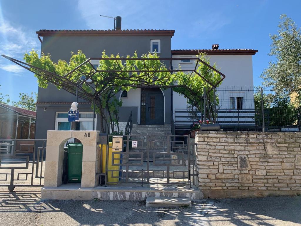 a house with a tree in front of it at Apartment Nina in Pula