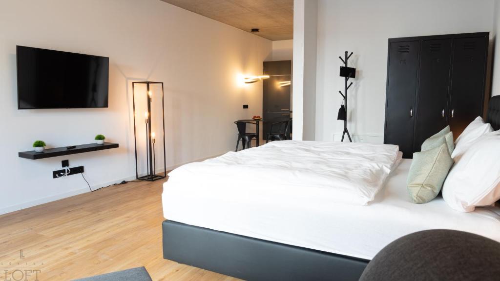 Postel nebo postele na pokoji v ubytování LÜTTES LOFT Boutique Hotel