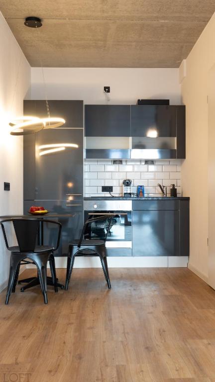 Kuchyň nebo kuchyňský kout v ubytování LÜTTES LOFT Boutique Hotel