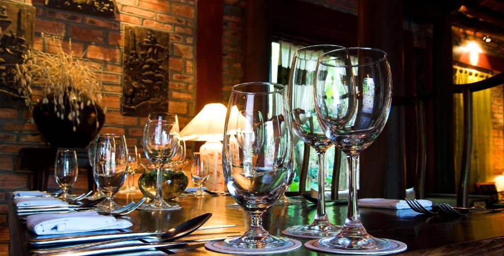 a row of wine glasses sitting on a table at Van Chai Resort in Sầm Sơn