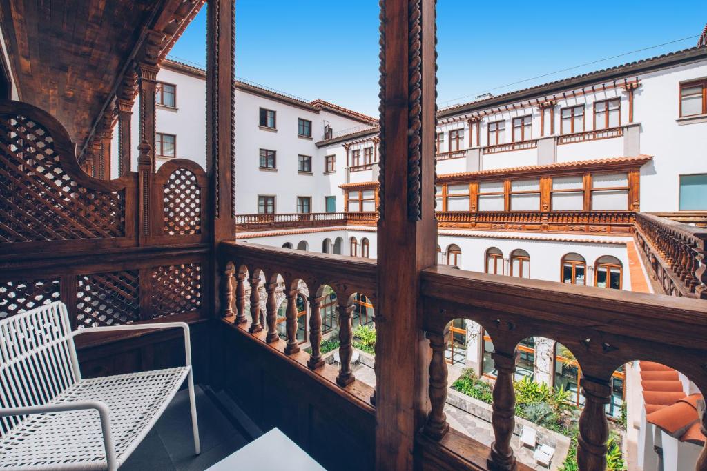 a balcony with a chair and a building at Iberostar Heritage Grand Mencey in Santa Cruz de Tenerife