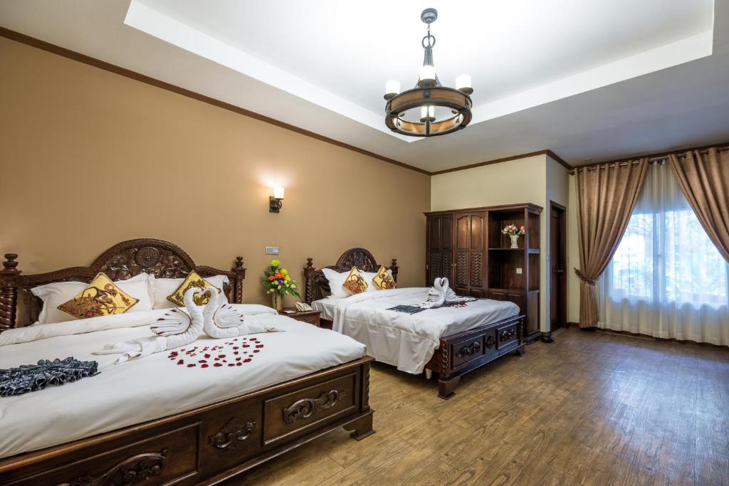 Postel nebo postele na pokoji v ubytování Bali Hotel