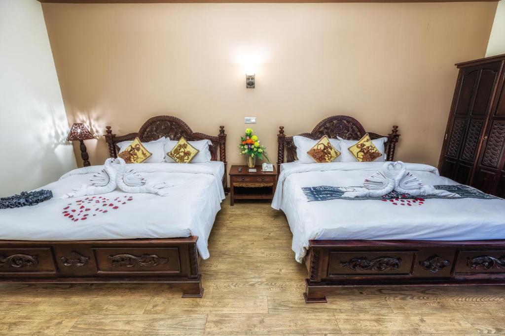 Postel nebo postele na pokoji v ubytování Bali Hotel