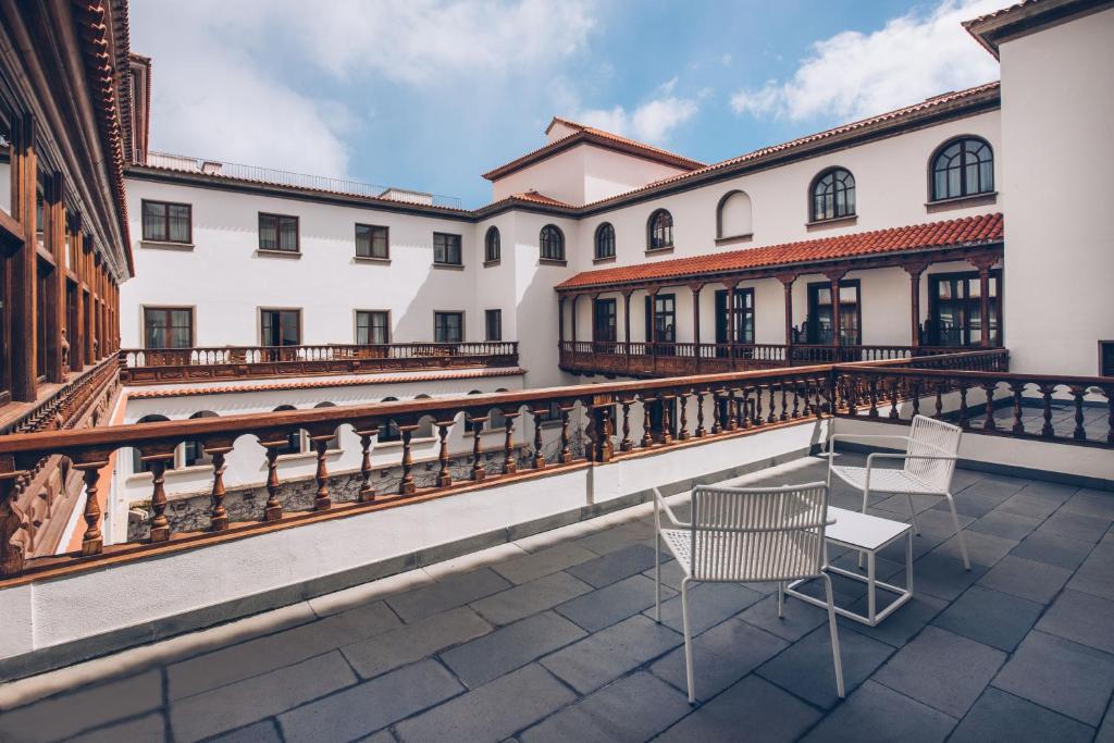 a group of chairs sitting on the balcony of a building at Iberostar Heritage Grand Mencey in Santa Cruz de Tenerife
