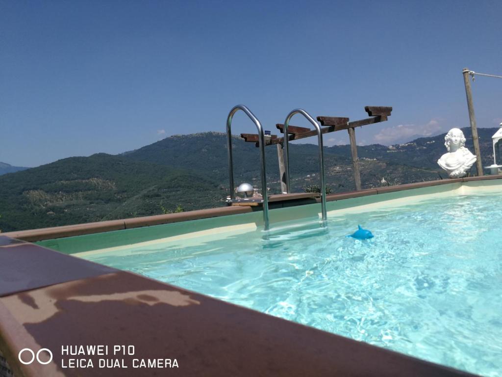 a swimming pool with a mountain in the background at Villa Anna in Torria