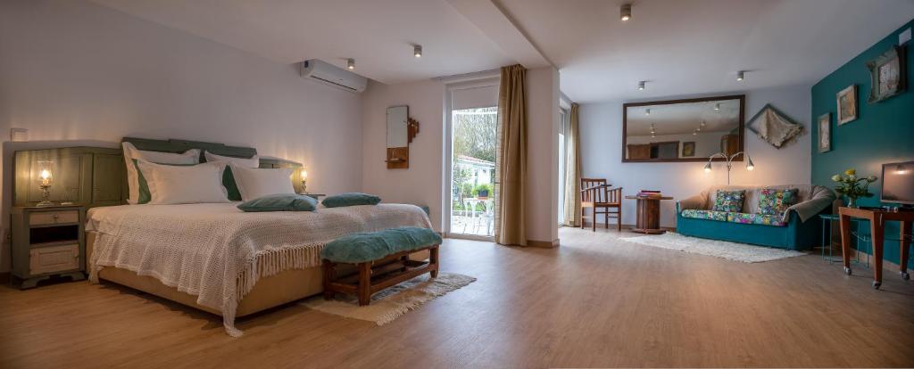 a bedroom with a bed and a living room at Casa dos Castanheiros in Vila Verde