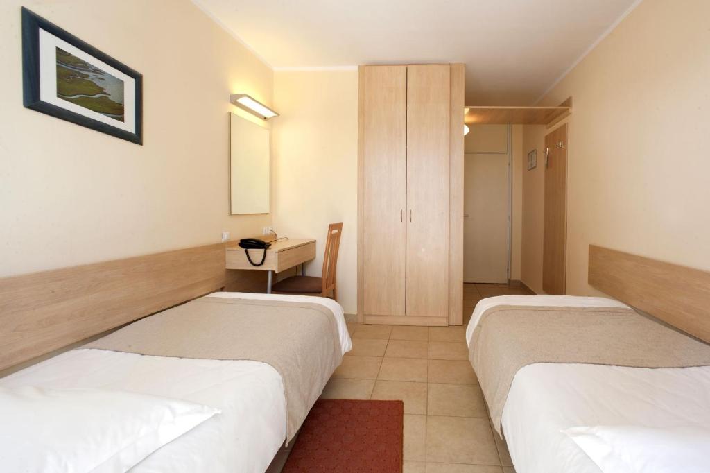 Postel nebo postele na pokoji v ubytování Hotel Delfin Plava Laguna