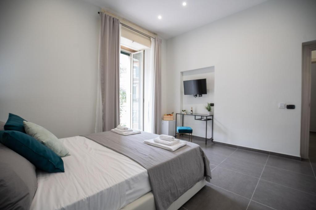 Posteľ alebo postele v izbe v ubytovaní Doria Suites Napoli