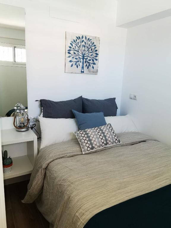 A bed or beds in a room at Lido Beachfront