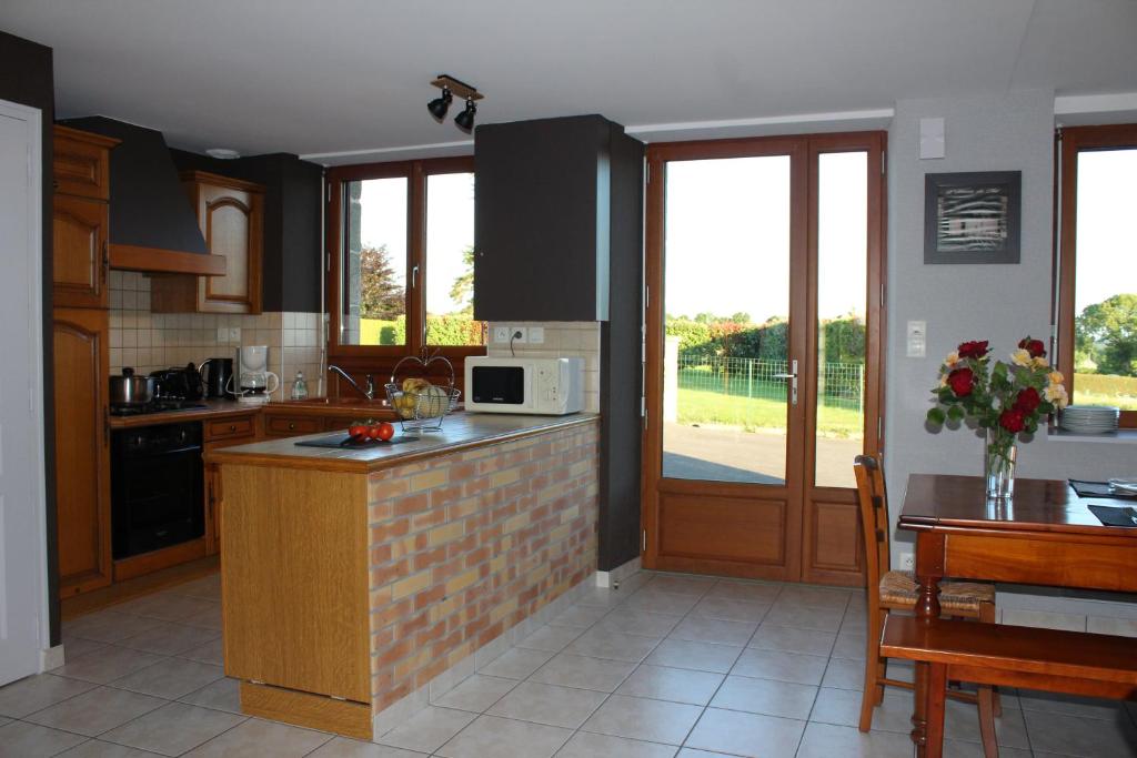 a kitchen with a sink and a counter top at Gîte La Loussaudrie in Pontmain