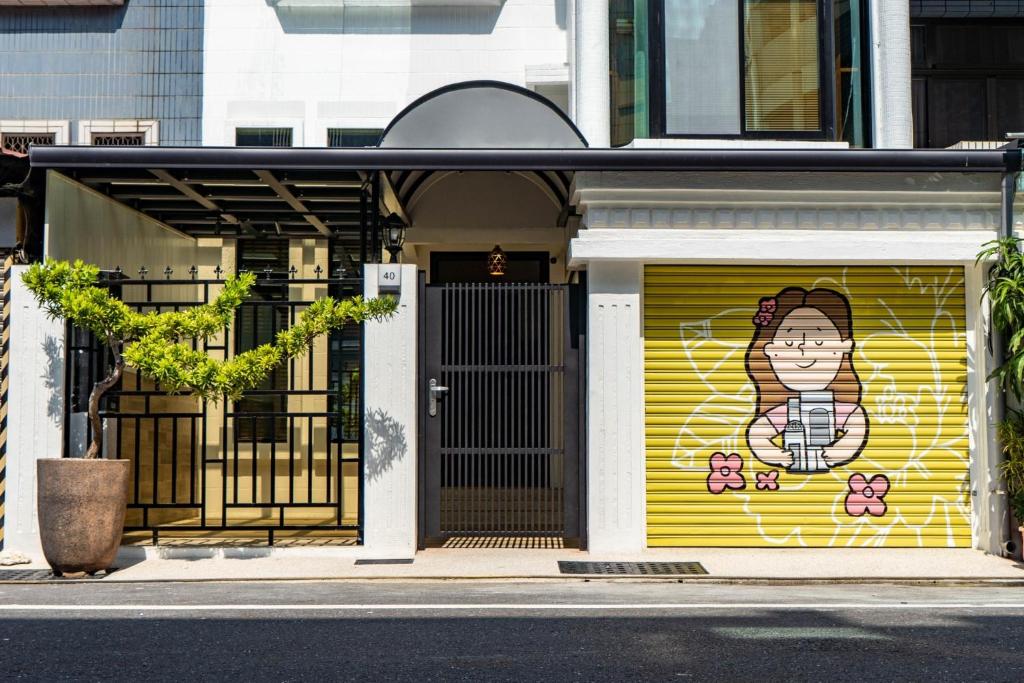a door with a painting of a woman on it at Flower House in Tainan