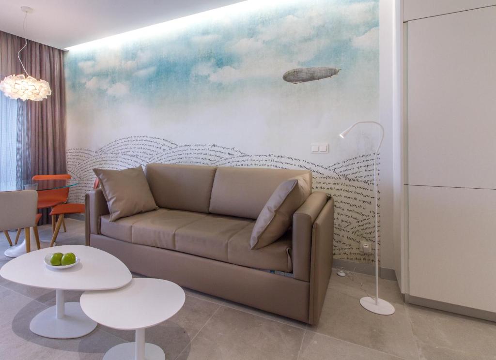 a living room with a couch and a painting at ESTIMAR Calpe Suitopia in Calpe