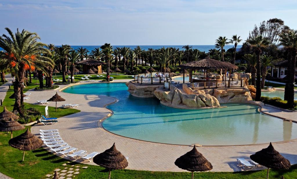 a large swimming pool in a resort with a water park at Sentido Phenicia in Hammamet