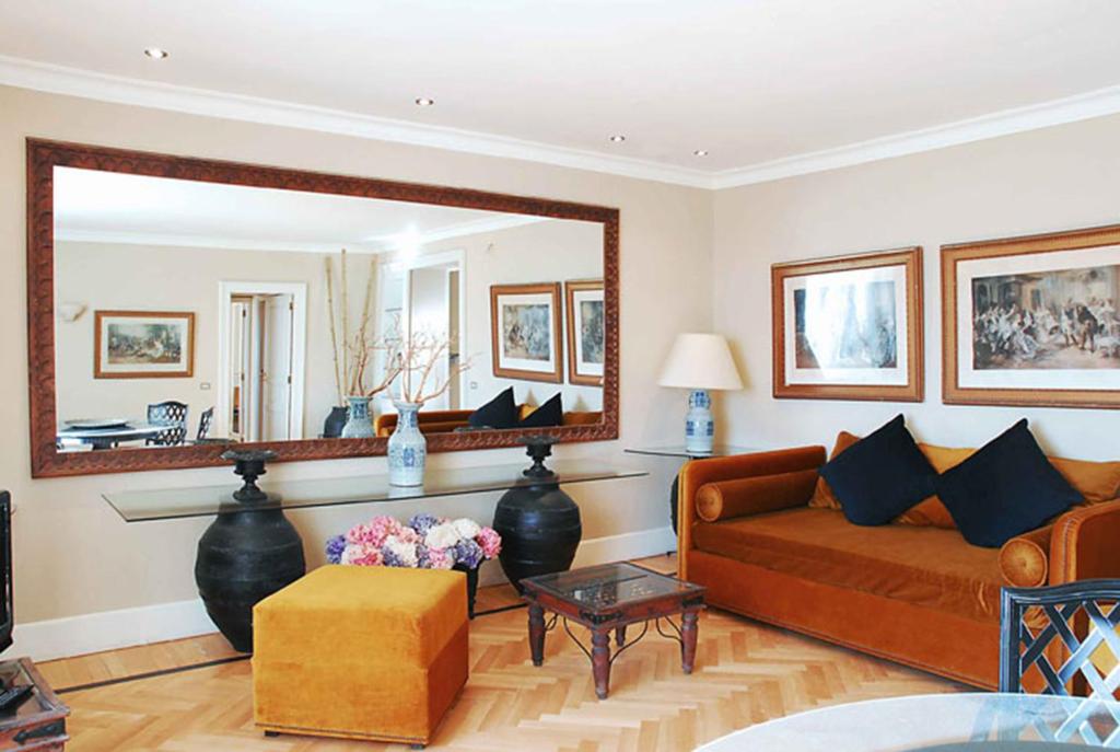 a living room with a couch and a mirror at Casa Rubinacci in Naples