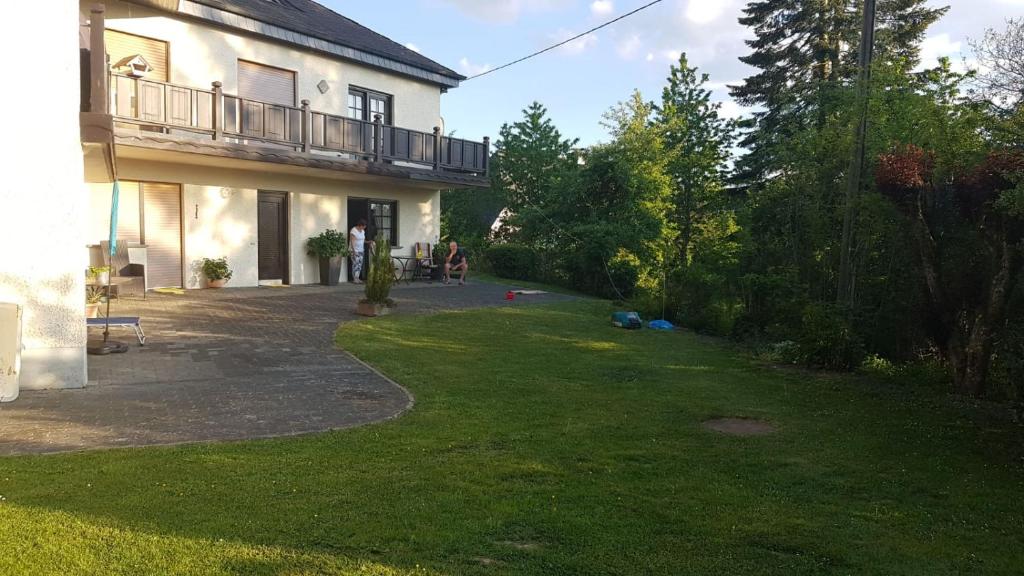 a yard of a house with a balcony at Haus Waldeck in Dasburg