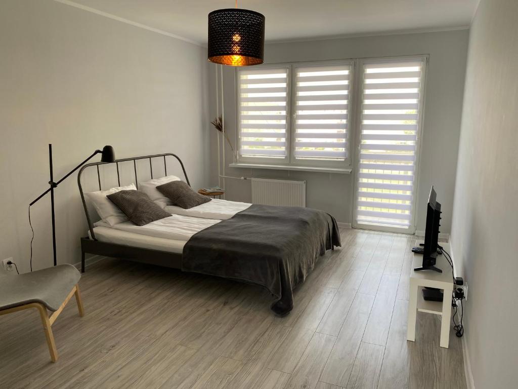 Posteľ alebo postele v izbe v ubytovaní APARTAMENT KILIŃSKIEGO 9