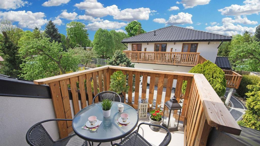 a balcony with a table and chairs on a deck at U Dorotki - Apartamenty i Pokoje in Sandomierz
